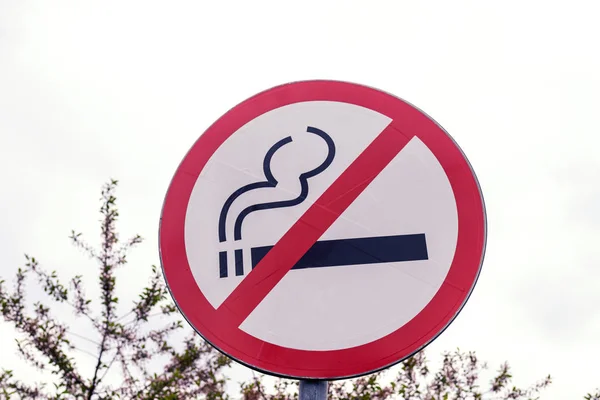 No smoking sign outdoors in the park. Cigarette, smoke, public place.