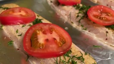 Baharat ve domatesli fırın tepsisinde taze balık. Yaşam tarzı görüntüleri.