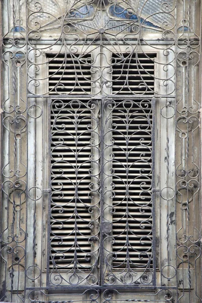 Wooden old window with iron bars — 스톡 사진