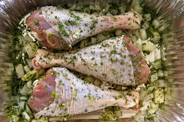 Turkey leg on steel board with herbs — Stock Photo, Image