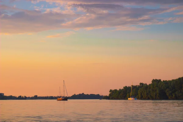 キエフ, ウクライナ-6 月3、2018: ヨットは川に沿ってスムーズに航行します。空はピンク. — ストック写真