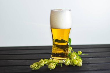 Bir bardak taze bira ile köpük döktü.