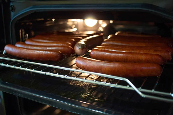 Cooking sausages in the oven. Fast food street. Fried sausages — Stock Photo, Image