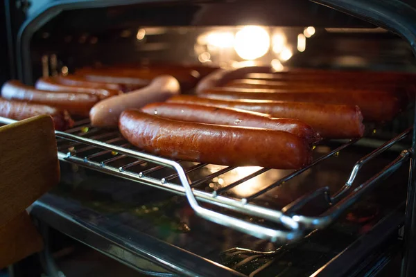 Cooking sausages in the oven. Fast food street. Fried sausages — Stock Photo, Image