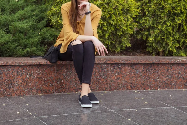 Mulher de blusa amarela clara e jeans pretos — Fotografia de Stock