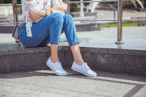 Legs in white sneakers — Stock Photo, Image