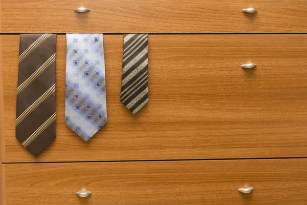 ties sticking out of the dresser
