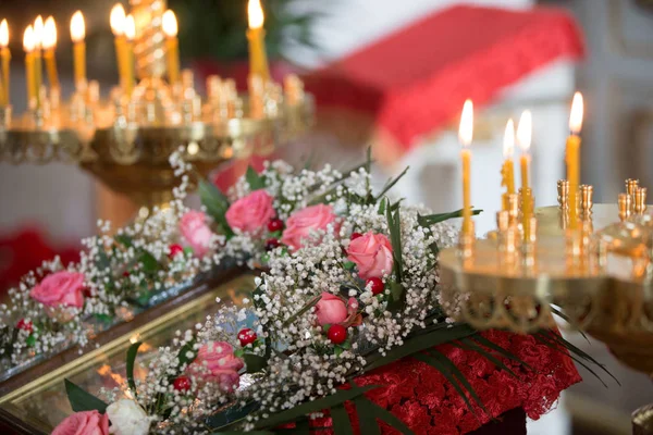 Orthodox altar with candles decorated with flowers