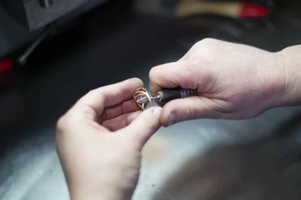 Industrial manufacture of the gold ring.Jeweler working on golden ring