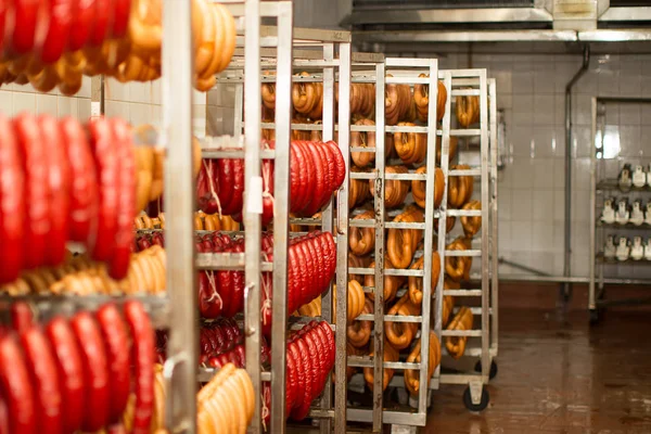 Sausages at the meat factory. Industrial cooking and smoking sausages at a meat factory