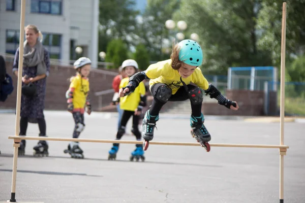 Beyaz Rusya, Gomel, 24 Haziran 2018. Central Park. Çocuk yarışmada silindir spor. Kız silindirler bir halter üzerinden atlar