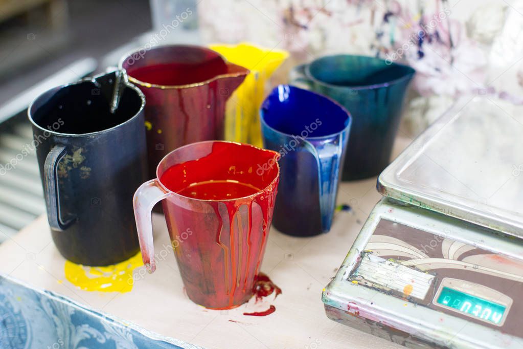 Multicolored industrial paint.Banks filled with industrial paint