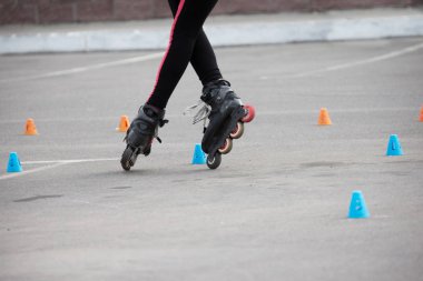 Competitions in roller sport.Roller skates and special chips clipart