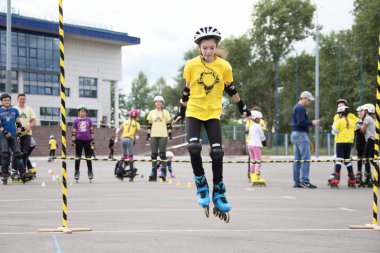 Beyaz Rusya, Gomel, 24 Haziran 2018. Central Park. Çocuk yarışmada silindir spor. Silindirler gurl halter atladı