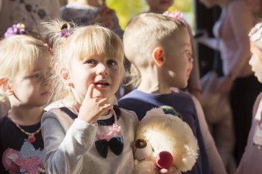 Belarus, Gomel, October 13, 2018. Holiday in the city. Children's Pavilion.Little girl looks at other children.