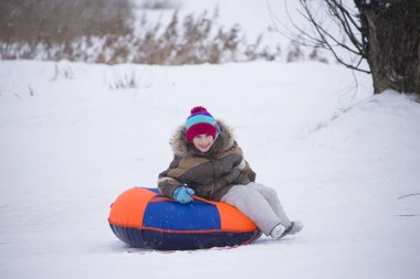 Sledding.Happy çocuk tatilde. Kış eğlence ve oyun. Küçük çocuk kızağı binmek zevk. Çocuklar açık havada karda oynamak. Çocuklar kızak kış Alp dağlarında