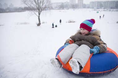 Sledding.Happy çocuk tatilde. Kış eğlence ve oyun. Küçük çocuk kızağı binmek zevk. Çocuklar açık havada karda oynamak. Çocuklar kızak kış Alp dağlarında