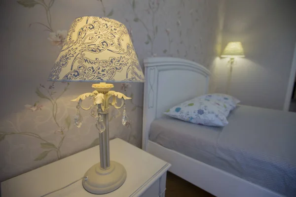 Interior with white bed and table lamp. Bedroom
