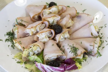 Yemeğin üzerine serilmiş et ruloları