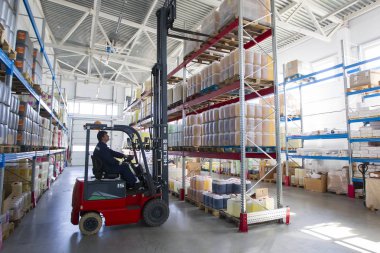 Belarus, the city of Mensk, April 12, 2019. Chemical production.Worker on a loader in a warehouse