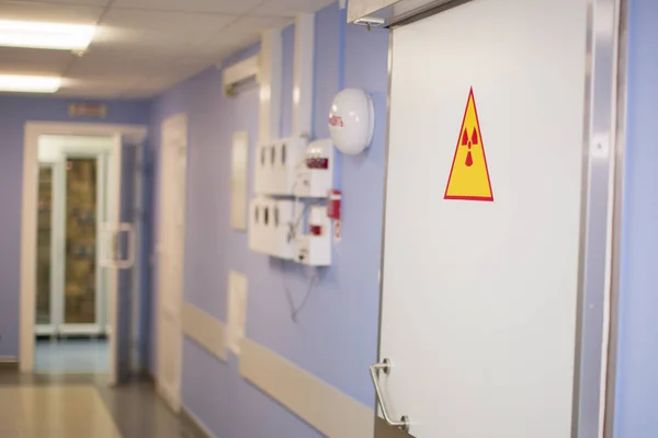 Radiological hospital corridor. Door with radiation sign
