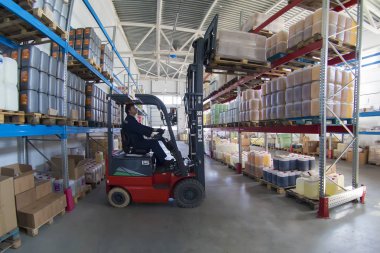 Belarus, the city of Mensk, April 12, 2019. Chemical production.Worker on a loader in a warehouse
