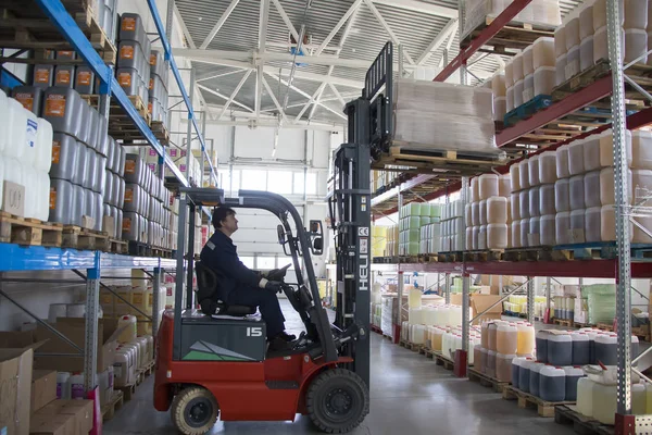 Belarus, the city of Mensk, April 12, 2019. Chemical production.Worker on a loader in a warehouse