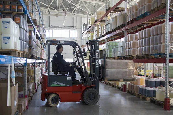 Belarus, the city of Mensk, April 12, 2019. Chemical production.Worker on a loader in a warehouse