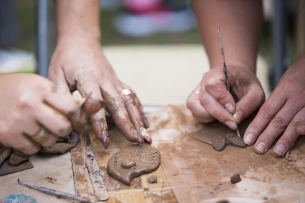 Hands make crafts from clay. Sculpt
