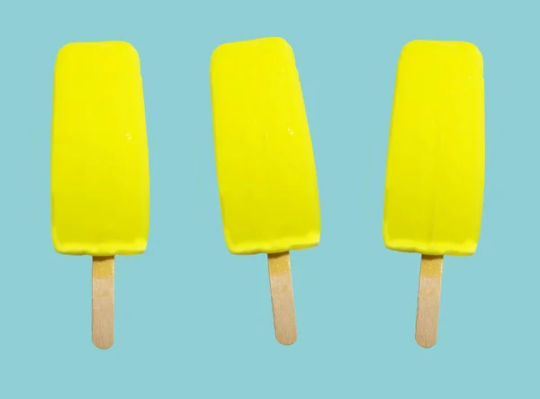 Three yellow ice cream on a stick on a blue background