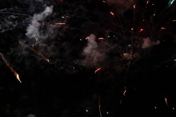 Fumaça e manchas de fogos de artifício em um fundo preto. — Fotografia de Stock