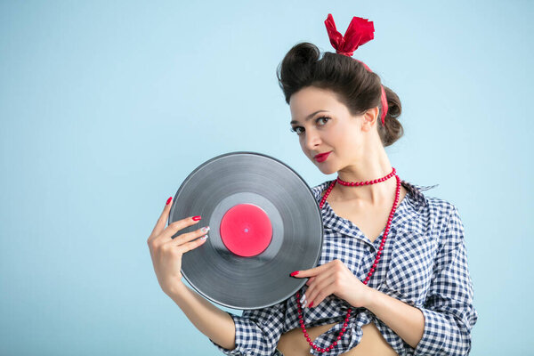 Retro girl with a record.Fifties style woman.