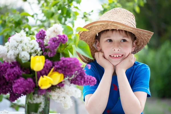 Bambino divertente in Panama con un mazzo di fiori. Ragazzo felice in estate. — Foto Stock