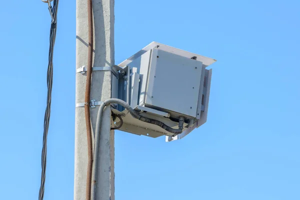 Speed camera car for surveillance on highway, tool of police for control road traffic. Speed radar cameras mounted on concrete pole against a clear blue sky. Speed control.