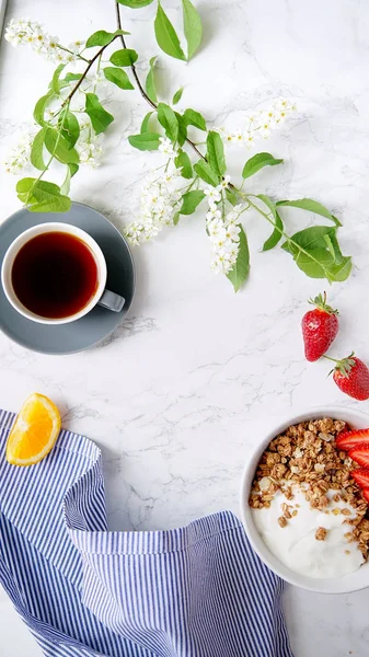Yoğurt ve çilek kase ve mermer masa üzerinde siyah kahve ile gevrek gevrek mükemmel kahvaltı