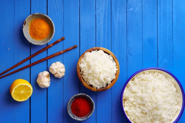 Bowls Cooked Jasmine Rice Colorful Spices Chopsticks Blue Wooden Background — Stock Photo, Image