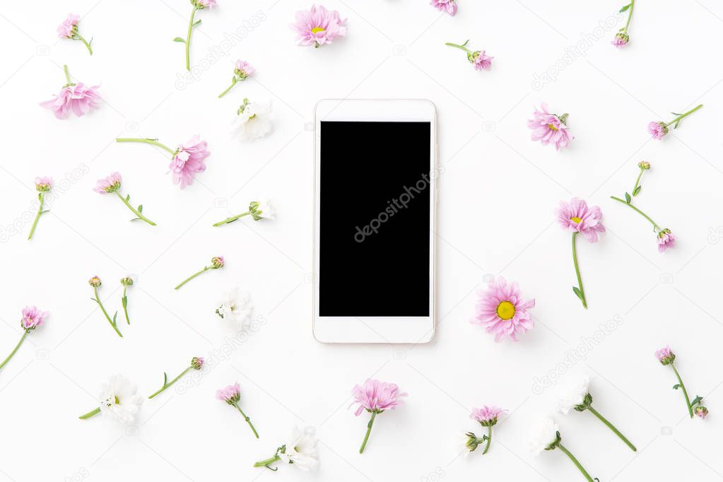 smartphone mock up and beautiful flowers isolated on white background, top view 