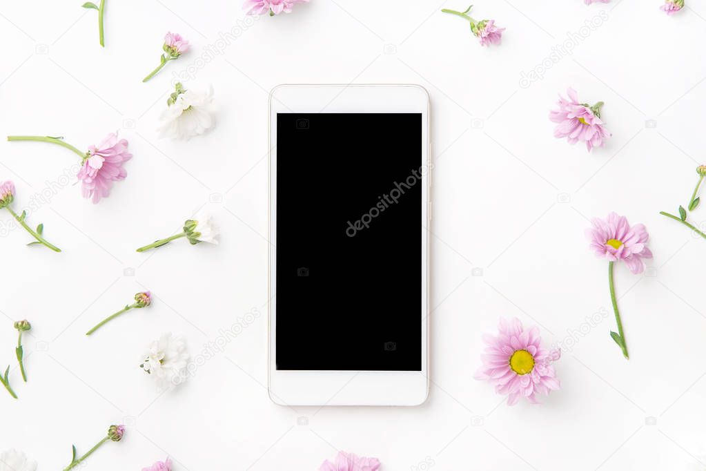 smartphone mock up and beautiful flowers isolated on white background, top view 