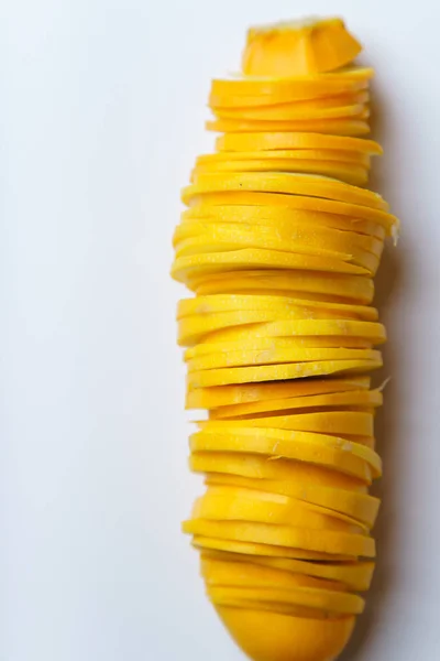 Pile of yellow squash slices isolated on white background