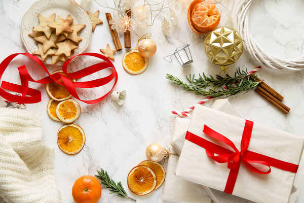 Christmas arrangement of gingerbread cookies with tangerines and new year decorations on marble background