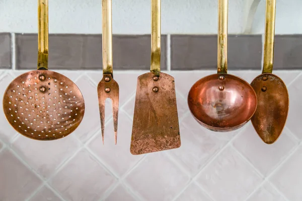 Copper Kitchen Utensils Spoons Spatulas Hanging Next Pink Tiles — Stock Photo, Image