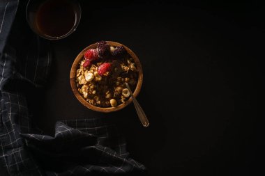 Ahududu ve böğürtlen Kupası ahşap kase kahve siyah masada granola 