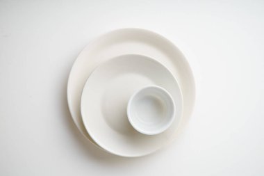 Beyaz arka plan üzerinde izole boş porselen tabak yığınını yakın çekim 