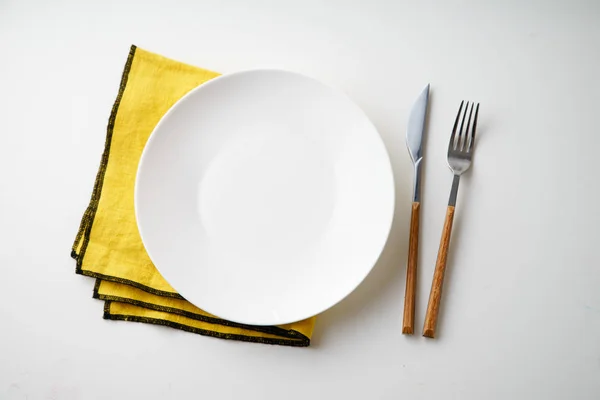 White Empty Plate Knife Fork Yellow Textile Napkin Isolated White — Stock Photo, Image
