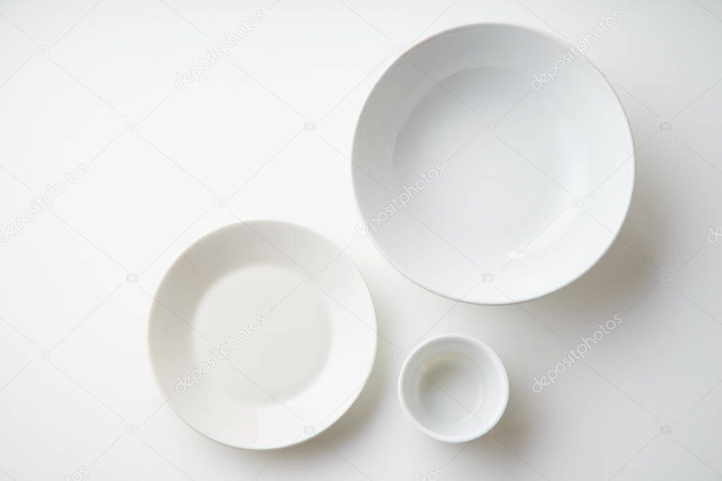 white empty porcelain plates isolated on white background, close-up 