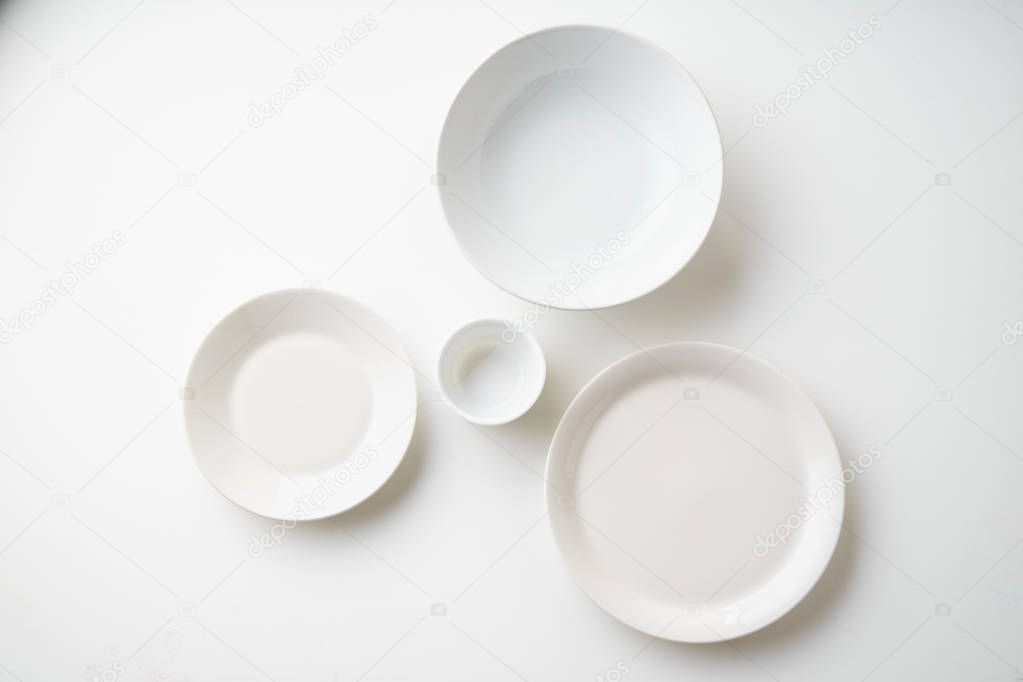 white empty porcelain plates isolated on white background, close-up 