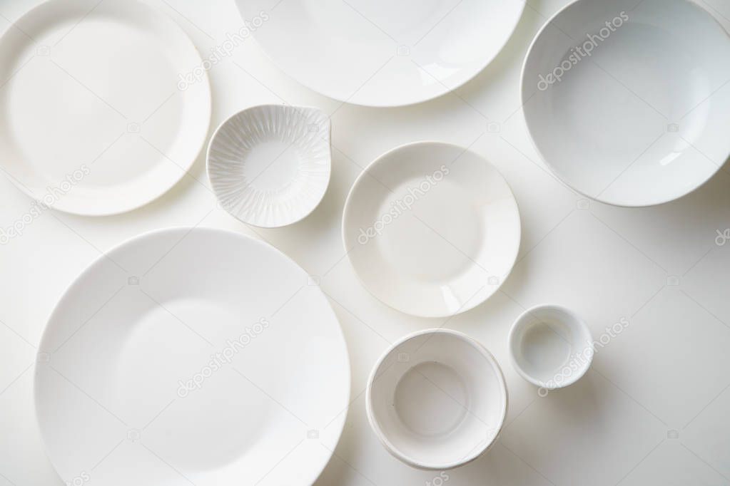 collection of porcelain plates isolated on white background, close-up 