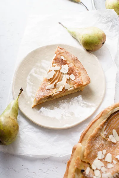slice of tart with poached pears and almond frangipane
