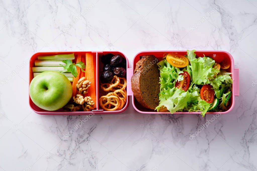 Lunch box with salad and healthy food for work and school 