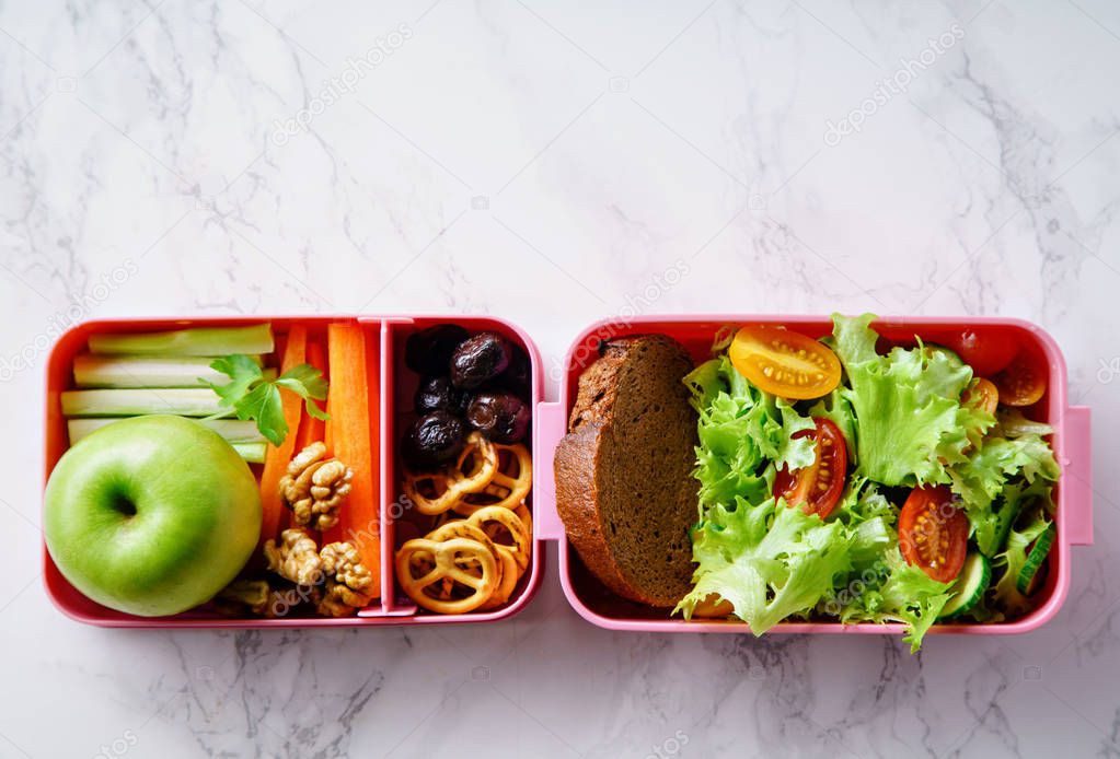 Lunch box with salad and healthy food for work and school 